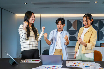 Vibrant business team consisting of diverse individuals joyfully raises their fists in celebration of a significant achievement, Celebrating success in a business team with joyful expressions