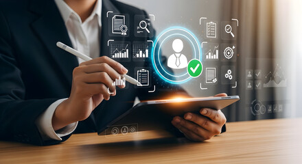 Businessperson analyzing data on a digital tablet.