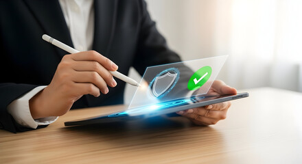 Business professional using a stylus on a tablet with a digital security shield and checkmark hologram.