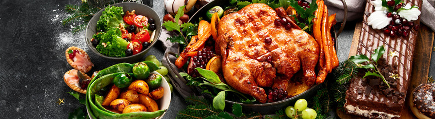 Festive dinner table with roasted chicken. Christmas family dinner.