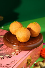 indian dessert on a plate yeloow laddu 