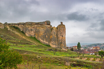 Summer landscape at cloudy morning with bizarre rocks of Goreme National Park and the Rock Sites of Cappadocia in Nevsehir Province in Cappadocia, Turkey. Stone pillars from basalt and tuff rocks