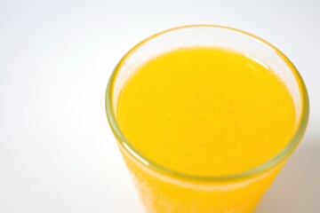 Orange juice in a glass on white background