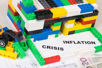House under construction made of toy blocks, polish currency money, housing plan. Rising costs of building or renovating home