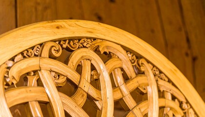 Intricate, detailed carvings adorn a light golden wooden panel, showcasing intricate patterns and meticulous craftsmanship.