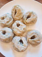 Steamed Korean dumplings Mandu filled with pork, cabbage, chives, and glass noodles