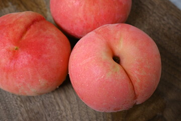 Close-up of fresh peaches on wooden surface