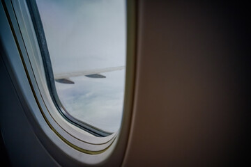 view from a window of air plane when flying on the cloud with air plane's wing outside