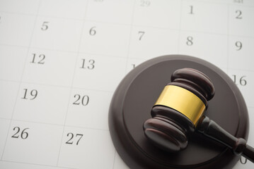 Judge wood gavel hammer on white blank calendar background copy space. Law, judgement, agenda...