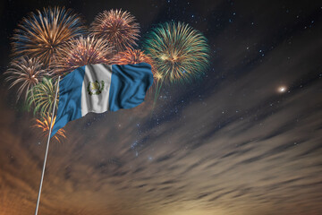 Waving National flag of Guatemala and holiday fireworks