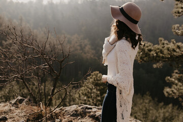 Woman in Hat Overlooking Forest Landscape