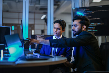 A diverse team of AI developers shares a successful moment in the office. A female programmer...