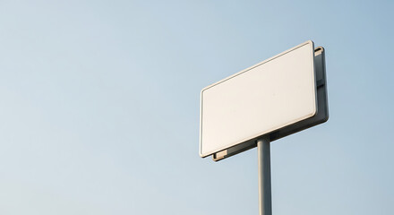Empty White Sign Template on Pole Against Clear Blue Sky