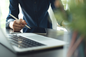 Architecture and interior design concept. Asian business woman architect using digital tablet for creating interior design project in studio office. Freelancer woman working in office, close up