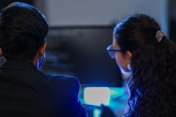 A diverse duo of AI developers in a pair programming session, analyzing a complex algorithm. A concept for teamwork, software engineering, and developing future technologies.