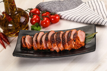 Sliced duck breast baked with cherry