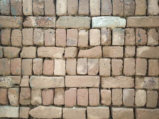 Rustic Brick Wall with Irregular Pattern, Weathered Texture, and Varied Brick Sizes