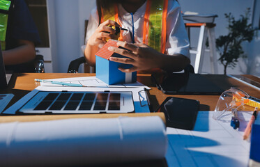 Closeup of team of industrial engineers meeting analyze machinery blueprints consult project on table in manufacturing factory. Working in manufacturing plant or production plant.