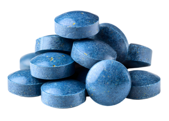 Heap of blue tablets isolated on a transparent background. Top view. Stock photo.