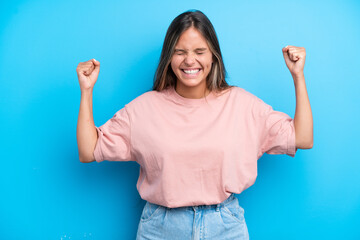 Young caucasian woman isolated on blue background doing strong gesture
