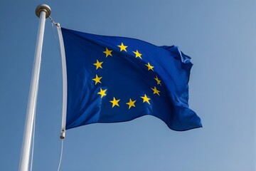 European Union flag waves on flagpole against blue sky