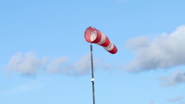Wind indicator - a red and white fabric cone indicating wind direction. It is used at airfields and chemical plants. The size of the horizontal strip indicates the wind speed.
