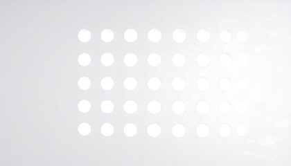 A grid of white circles on a light gray background.  Soft, diffused light