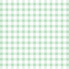 Seamless four-leaf clover pattern. St. Patrick's Day background with green shamrock symbols of good luck for spring holiday wrapping paper or textile design.