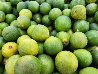 A Close-Up View of Bright, Fresh, Juicy Limes in a Market Display