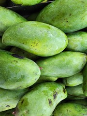 Close-Up of Fresh Green Mangoes in a Market Setting