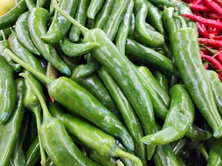 Fresh Green Chili Peppers Piled Together with Vibrant Red Chilies Nearby