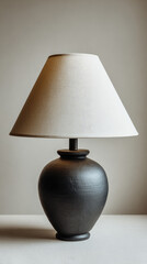 Table lamp with black ceramic base and white fabric shade