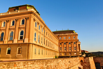 elevation perspective of the Buda castle in Budapest, Hungary at sunrise. historic landmark building on the Buda hill by the Danube housing the Art Gallery. popular tourist attraction. travel concept