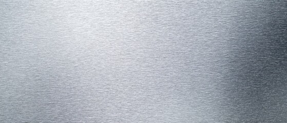 The Brushed Metal Surface Texture Background with Subtle Gradient and Fine Grain