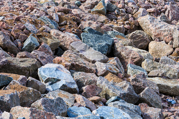 There are stones of various sizes and shapes on the surface. The background image.