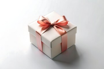 Obraz premium Elegant white gift box with a peachcolored ribbon and bow isolated on white background