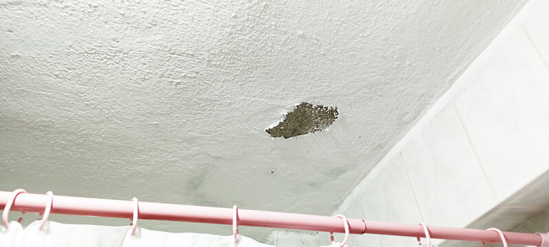 water and moisture damage damaged room ceiling.damaged and stained interior ceiling due to water leak.stained bathroom ceiling