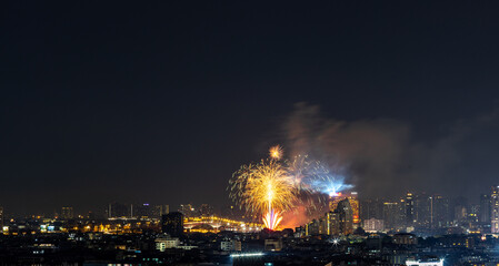 Fototapeta premium Blurred background of night lights in Bangkok. Fireworks, traffic lights, lights on bridges over the river, the spread of electric lighting technology in homes.