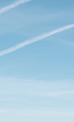 Expansive and Vibrant Blue Sky Showcasing Two Delicate, Fluffy White Clouds Drifting Gently, Evoking a Sense of Serenity, Openness, and Natural Tranquility Perfect for Reflective Concepts