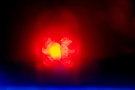 Red color light leaks on dark black background. Design and special effect. Random shapes and tone.