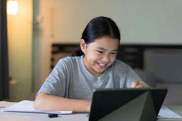 study online class by asian child smile learning on computer tablet or kid girl student fun...