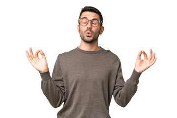 Naklejka premium Young handsome caucasian man over isolated background in zen pose