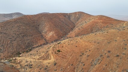 desert place where the scarce vegetation meets the mountains and the sand 