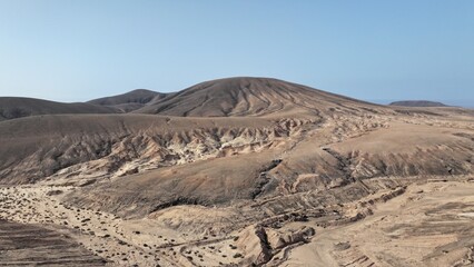 desert place where the scarce vegetation meets the mountains and the sand 