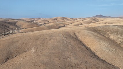 desert place where the scarce vegetation meets the mountains and the sand 