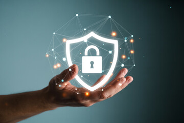 Hand holding a digital shield icon representing cybersecurity protection and safety