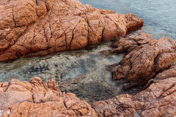 Pink granite coastal rocks and clear turquoise sea water. Natural seascape photography. Coastal landscape and travel destination concept. Design for poster, wallpaper, postcard. Top view.  © Tetiana Moish