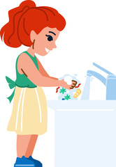Young girl washing dishes in kitchen sink