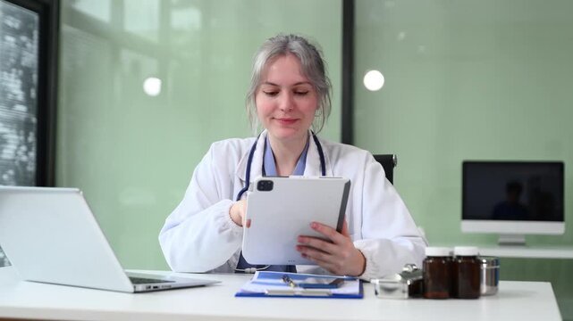female doctor working on patient records and using a laptop. Perfect for healthcare, telemedicine, online consultation, and medical services visuals.