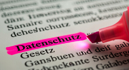 German data protection law highlighted with a pink marker on a document focused on legal text and privacy regulations